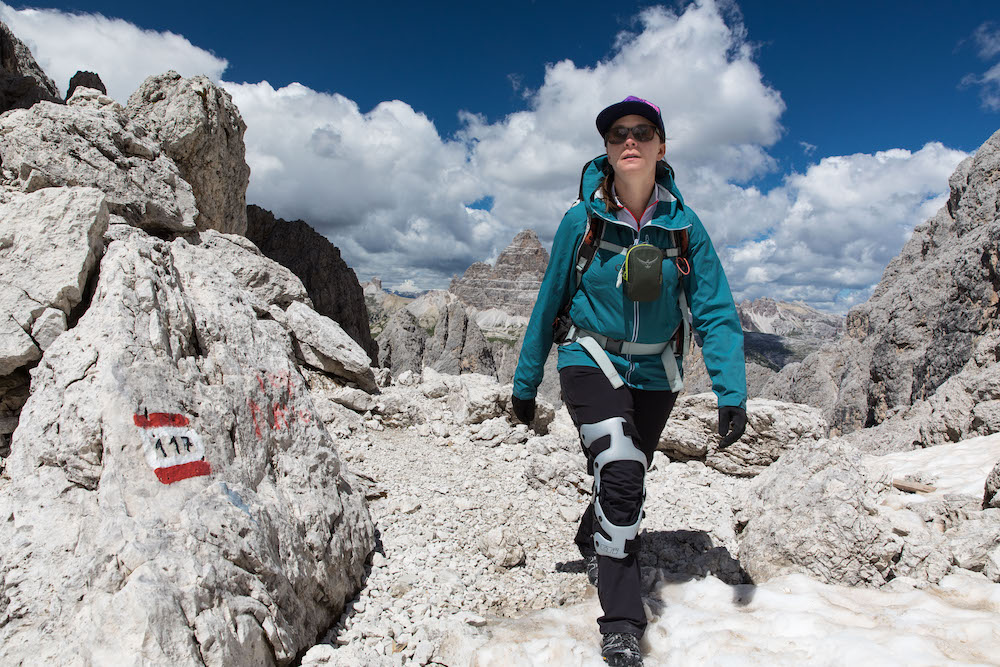 Woman hiking over rocky terrain in the Dolomites