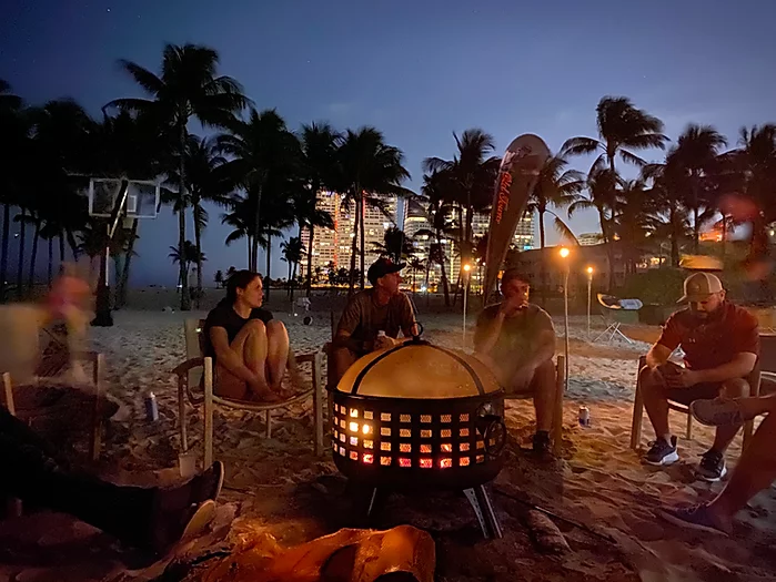 Group storytelling around a beach bonfire