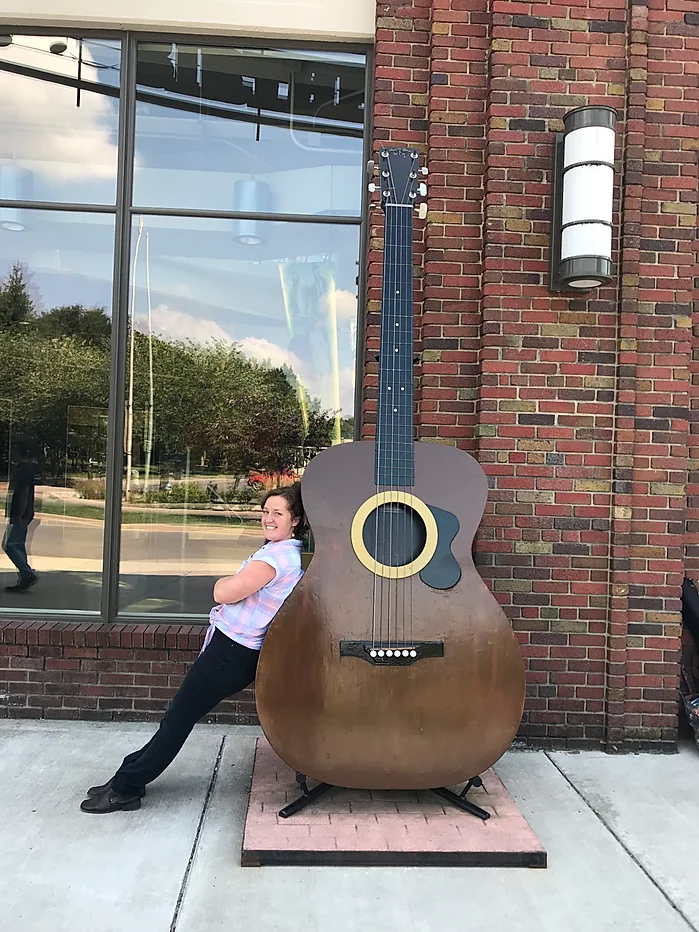 Hannah with giant guitar