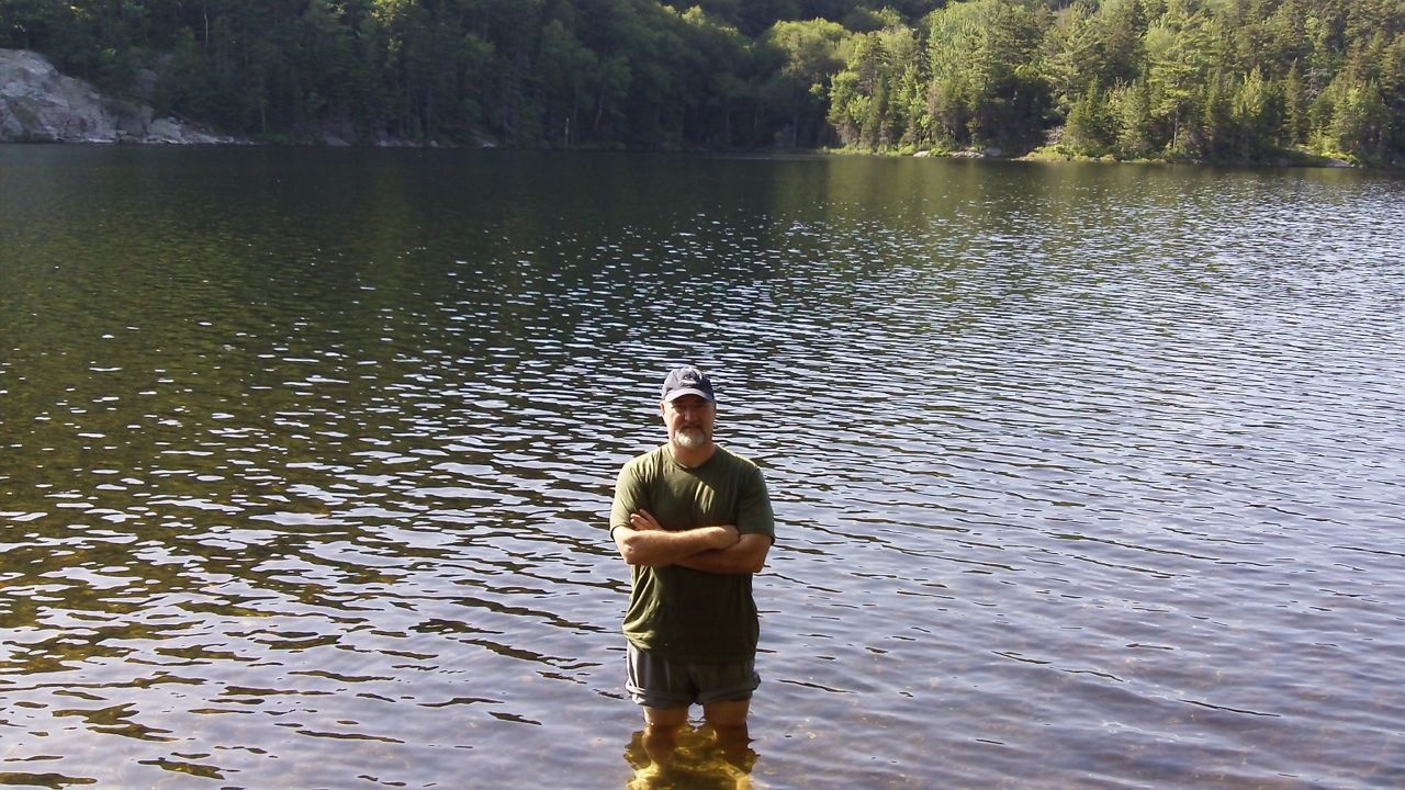 Man standing in an alpine lake