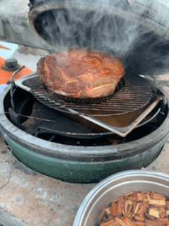 A piece of ham in a smoker
