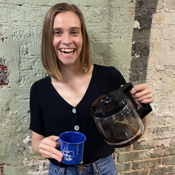 Picture of a woman smiling and pouring a cup of coffee