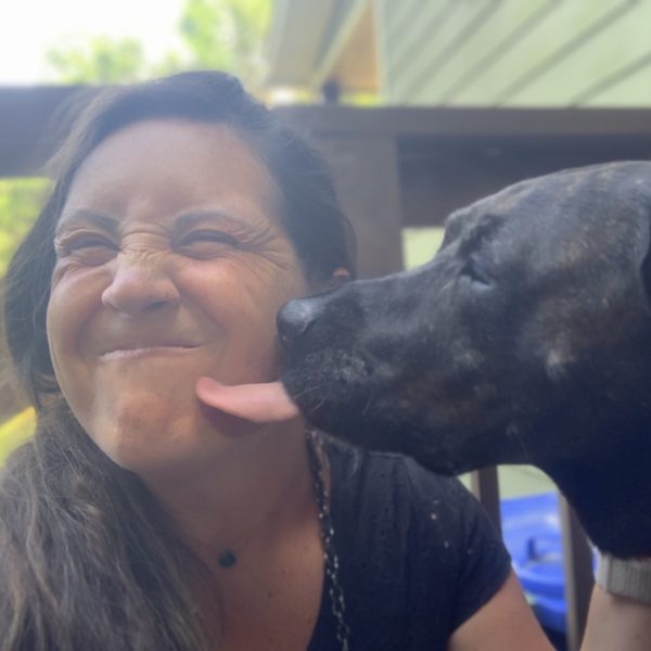 Mindy Smith with her dog licking her cheek