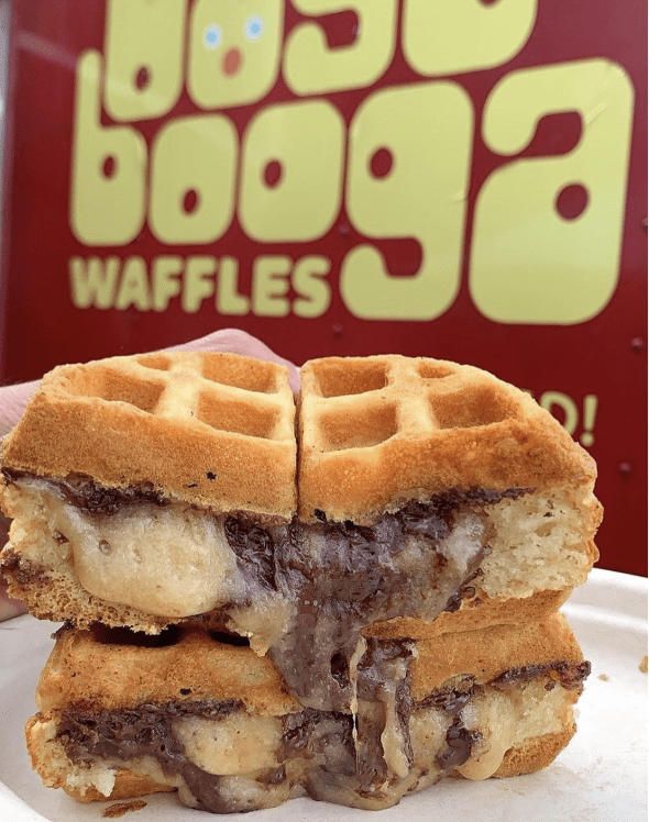A stuffed waffle with bananas and chocolate oozing out