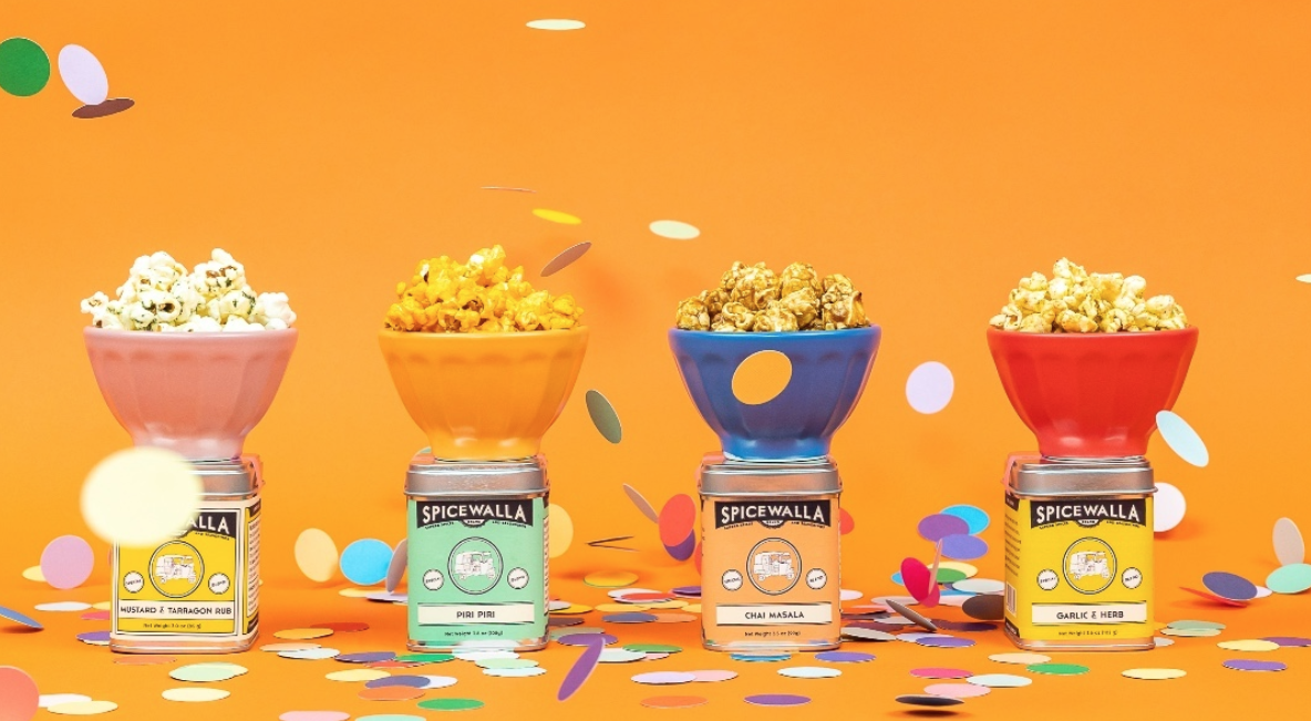 Image of Poppy popcorn in bowls on top of tins of Spicewalla