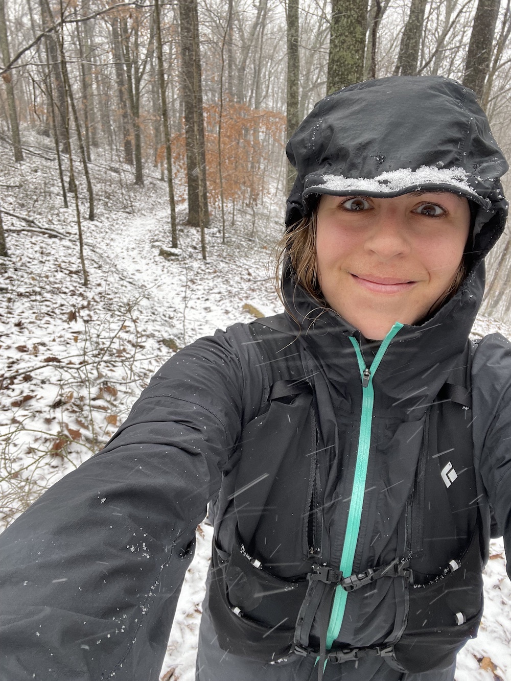 Woman taking a selfie in the snow on a trail