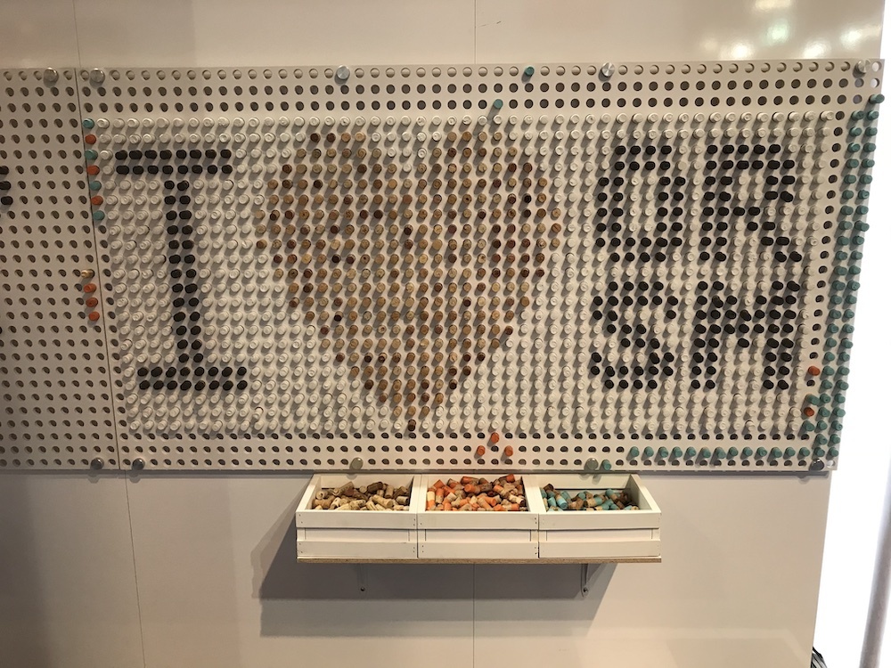 Image of wall at Outdoor Retailer trade show with corks spelling out I Heart ORSM 